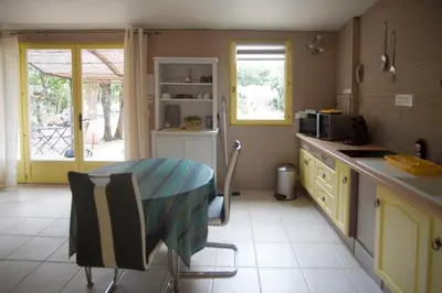 a kitchen with a table and a counter top at La Pitchounette Mas Val-Chênaie Gordes in Gordes