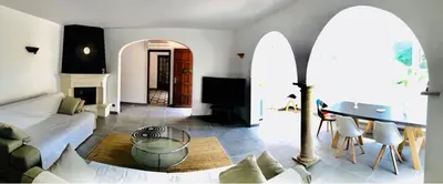a living room with a couch and a table at Villa in Provence with private pool in LʼIsle-sur-la-Sorgue