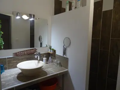 a bathroom with a sink and a mirror at Les Ecrins d'Aix-en-Provence in Aix-en-Provence