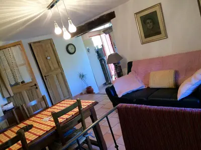 a living room with a couch and a table at L'Oustaou de Rose in Bonnieux