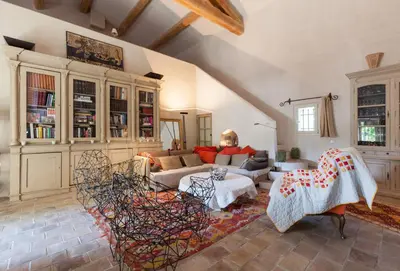 a living room with a couch and a table at La Louvière des Bruyères in Robion en Luberon