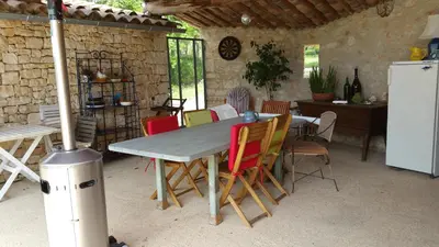 a table and chairs in a kitchen with a refrigerator at Coin Secret in Murs