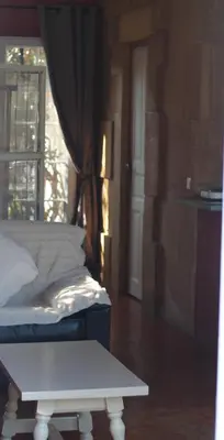 a bedroom with a bed and a window and a table at Gites Climatisés Piscine Chauffée La Balancelle in Saint-Rémy-de-Provence