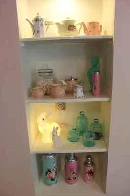 a cupboard filled with lots of dishes and toys at Les intérieurs d'Angèle in Pernes-les-Fontaines