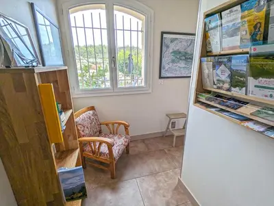 a room with a refrigerator and a chair and a window at Le Panorama des Alpilles in Aureille
