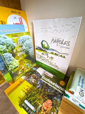 a bunch of books sitting on top of a table at Le Panorama des Alpilles in Aureille