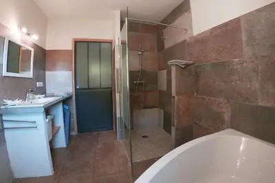 a bathroom with a shower and a tub and a sink at Le Panorama des Alpilles in Aureille