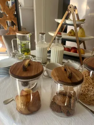 a table topped with jars of food and milk at Le Mas Angelussi - Le Clos du Soleil in Salon-de-Provence
