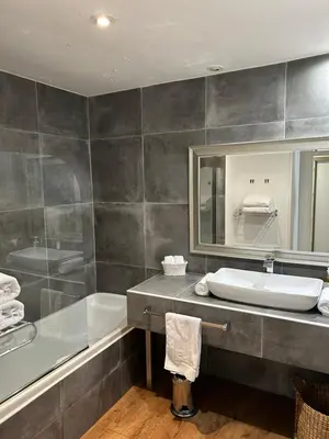 a bathroom with a sink and a tub and a mirror at Le Mas Angelussi - Le Clos du Soleil in Salon-de-Provence