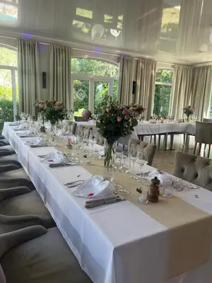 a long table with white table cloths and flowers on it at Le Mas Angelussi - Le Clos du Soleil in Salon-de-Provence