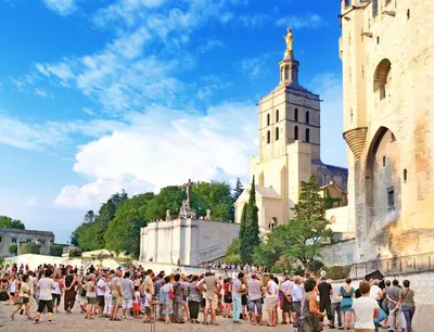a crowd of people standing in front of a castle at BlueBird in Cavaillon