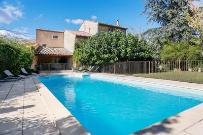 a swimming pool in front of a house at Villa confortable à Caromb avec piscine privée in Caromb