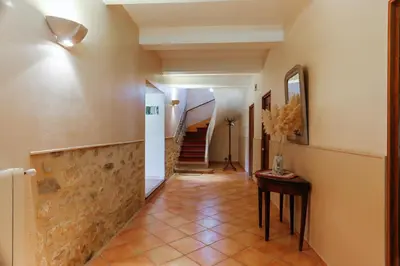 a hallway with a tile floor and a staircase at Villa confortable à Caromb avec piscine privée in Caromb