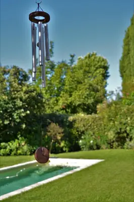 a group of wind chimes hanging in a park at Le Chat Sur Le Toit in Lourmarin