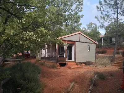 a small house in the middle of a yard at La Colline des Ocres Village de vacances 3 étoiles in Apt