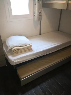 a bed in a bunk room with towels on it at La Colline des Ocres Village de vacances 3 étoiles in Apt