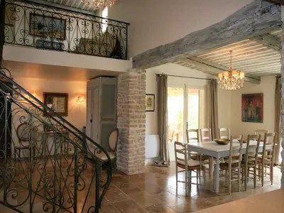 a dining room with a table and chairs at Mas in Eygalières with Heated Pool in Eygalières