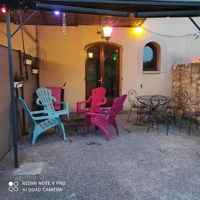 a group of chairs and tables on a patio at le Mas de la Jardine in Velleron