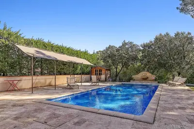 a swimming pool with a tent and a house at Villa Les Cedres in Aix-en-Provence
