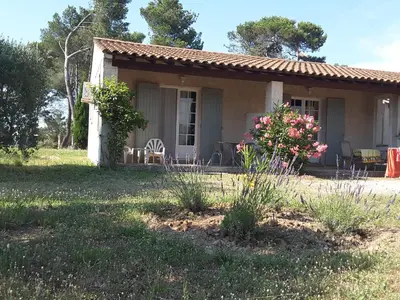 a small house with a table and chairs in a yard at Mas Clair de Lune in Saint-Rémy-de-Provence