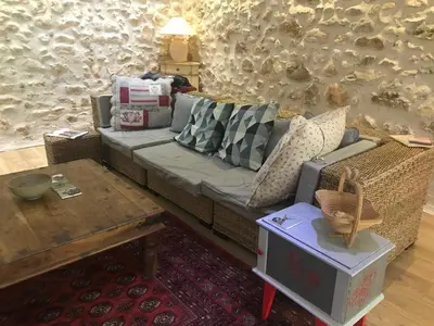 a living room with a couch and a table at Oustau du Ventoux in Bédoin