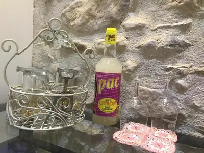a bottle of wine and glasses on a table at Oustau du Ventoux in Bédoin