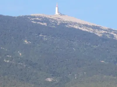 a lighthouse on top of a hill with trees at Oustau du Ventoux in Bédoin