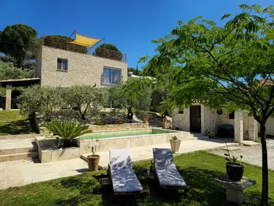 a villa with a swimming pool and a house at Le Mas de la Tortue (Plain Pied) in Caromb