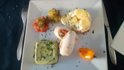 a white plate with eggs and other food on it at Les Figues in Caromb