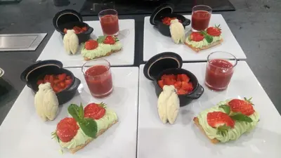 a table topped with plates of food with strawberries at Les Figues in Caromb