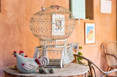 a bird cage sitting on top of a table at Poterie de Pierroux in Roussillon