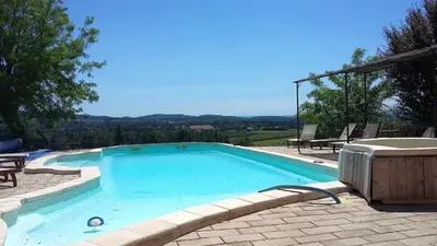 a large swimming pool with a view of the mountains at Olivier in Mazan