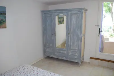 a bedroom with a gray cabinet with a mirror at Olivier in Mazan