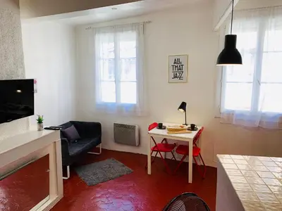 a small living room with a table and a chair at Granet Studio in Aix-en-Provence