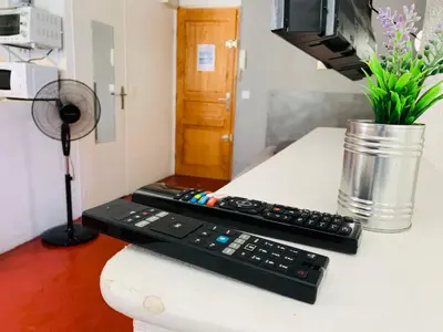 two remote controls sitting on top of a counter at Granet Studio in Aix-en-Provence