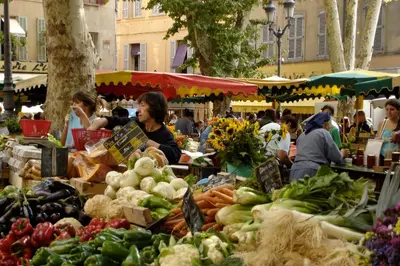 a market filled with lots of vegetables on display at Granet Studio in Aix-en-Provence