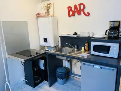 a small kitchen with a sink and a microwave at Mirabeau Studio in Aix-en-Provence