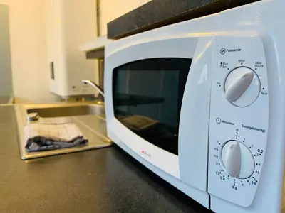 a microwave oven sitting on top of a kitchen counter at Mirabeau Studio in Aix-en-Provence