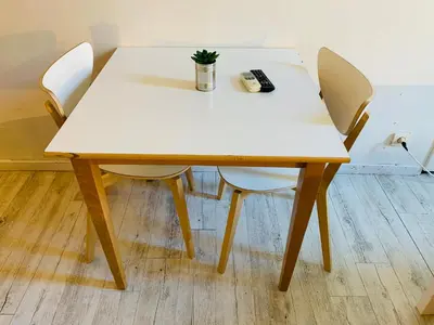 a table with two chairs and a remote control on it at Mirabeau Studio in Aix-en-Provence