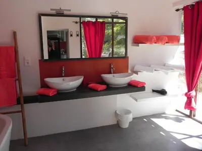 a bathroom with two sinks and a mirror at La Bastide des Vasses l'Atelier in Cucuron