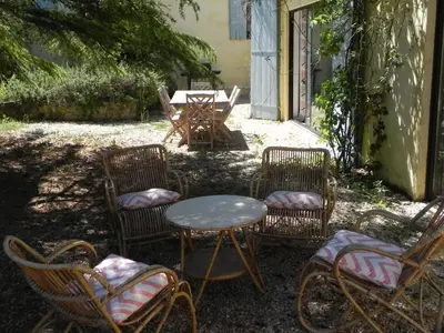 a group of chairs and a table and a table and chairs at La Bastide des Vasses l'Atelier in Cucuron