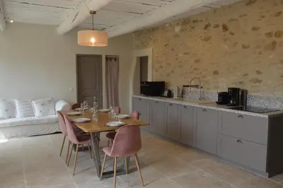 a kitchen and dining room with a table and chairs at Les Gîtes Du Clos D'Olea in Oppède