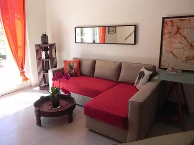 a living room with a couch with a red blanket at La Bastide des Vasses 