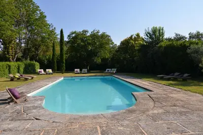 a swimming pool in a yard with chairs and trees at Domaine Shambala - gîte en Provence avec une Grande Piscine in Velaux