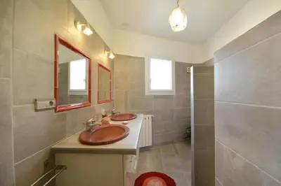 a bathroom with two sinks and a shower at Villa charmante à Saint-Didier avec piscine privée in Saint-Didier