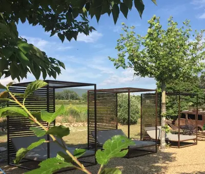 a garden with a pergola and a tree at Le Vieux Portail in Saint-Saturnin-les-Apt