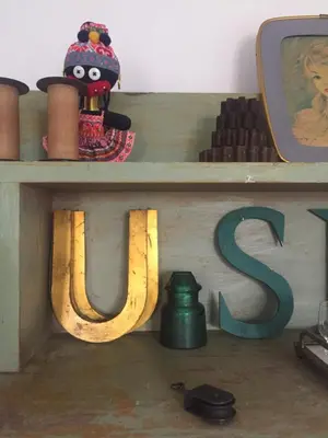 a wooden table with a letter s on it at Le 40 in LʼIsle-sur-la-Sorgue
