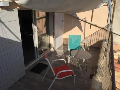 a balcony with chairs and a table on a house at Studio avec Terrasse in Aix-en-Provence