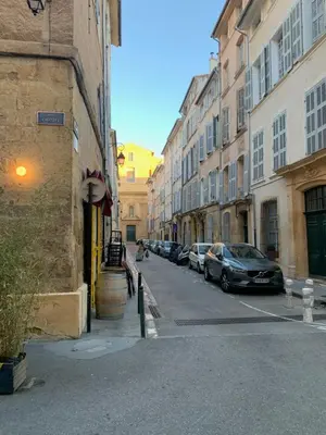 a city street with parked cars and buildings at Studio avec Terrasse in Aix-en-Provence