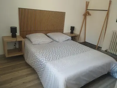 a bedroom with a large white bed with two pillows at les oliviers in Carpentras